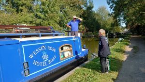 A chaplain on the towpath speaking with a boater